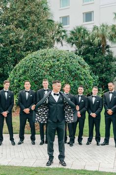 a group of men in tuxedos standing next to each other