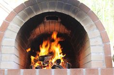 a brick oven with fire burning in it