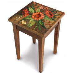 a small wooden table with flowers painted on it