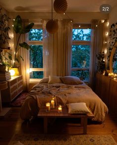 a bed room with a neatly made bed and candles