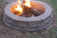 a fire pit made out of bricks in the grass