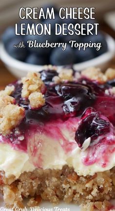 a close up of a dessert on a plate with blueberries and crumbs