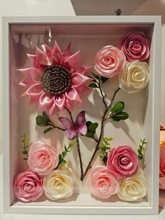 pink and white flowers in a shadow box