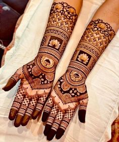 two hands with henna designs on them