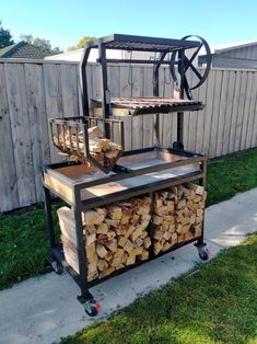 a cart filled with firewood next to a fence