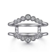 two stacking rings with diamonds on each side, one in white gold and the other in