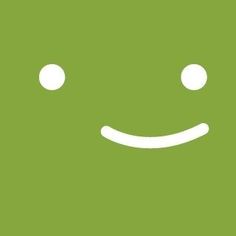 a green square with two white circles on it and a smiling face in the middle