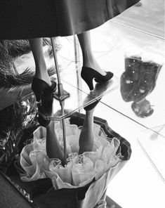 woman's legs in high heeled shoes on display at store window with reflection