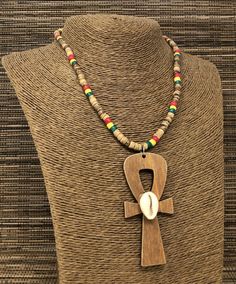 "Rasta Beaded Necklace. Natural Wood Ankh Necklace Pendant. Handmade Ankh Wooden Pendant. Unisex Design. Necklace is 17\" Inches Around the Neck Meaning of Ankh Cross: ancient symbol of life on Egypt Ankh Pendant Dimensions: 3\" Inches Long FAST & FREE SHIPPING! Visit my Etsy Shop to see more Handmade Africa Jewelry! At Freedom Life Style Jewelry you will find a variety of Africa Necklaces and Africa Earrings. Click here to see more designs: https://www.etsy.com/shop/FreedomLifeStyle" Traditional Beaded Chain Jewelry For Beach, Amulet Style Wooden Beaded Necklaces For Gifts, Amulet Style Wooden Beaded Necklace As Gift, Amulet Style Wooden Beaded Necklace For Gifts, Traditional Polished Bead Necklaces For Beach, Traditional Brown Beaded Chain Jewelry, Traditional Long Necklace For Beach, Traditional Polished Beads Necklace For Beach, Amulet Style Jewelry With Wooden Beads For Festival