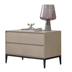 a nightstand with a lamp on top of it