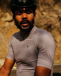 a man wearing a helmet and riding a bike