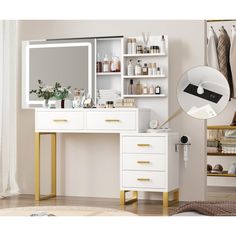 a white desk with gold legs and drawers in front of a mirror that is hanging on the wall