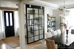 the dining room table is set with white chairs