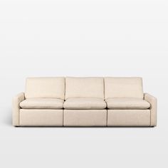 a white couch sitting on top of a white floor