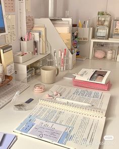 the desk is cluttered with books, papers and other things to do on it