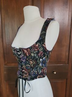 A beautifully cut and constructed corset style vest with reversible sides for two ways to be worn. Both sides of the fabric are very thick and sturdy, therefore being able to provide shape and structure without boning. This garment does not have any boning, but very much provides waist definition and bust support. This piece has a gorgeous wide scopped neckline that is extremely flattering. It is handmade with no official sizing, although it fits like an extra small to small. Please refer to the measurements below that are taken fully laced shut. This garment is meant to be worn by a pers with slightly larger measurements so it can sinch you in as it is laced shut. Measurements: (inches/flat) Armpit to armpit- 16 Waist- 13.5 Center front length- 9.5 Armpit to waist- 7.5 Shoulder to armpit- Style Corset, Corset Vest, Style Vest, Dark Floral, Corset Style, Women's Costumes, Favorite Outfit, Porter, Lavender