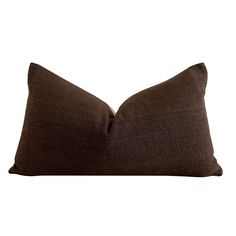 a brown pillow sitting on top of a white wall