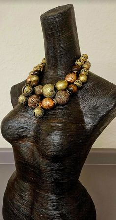 Look at how stunning this African oversized beaded tribal statement necklace is! The components include Yoruba brass beads (with imperfections), Ethiopian copper beads, a Tibetan copper repousse accent bead, chocolate brown round wood beads, burnished gold tone metal wavy spacers, rhinestone rondelles and African glass hand painted beads. Despite the heavy look, this is actually quite lightweight as most of the metal beads are hollow. Adjusts from 19-21" and I can add additional chain links free Bronze Bohemian Necklace With Large Beads, Bohemian Bronze Necklace With Large Beads, Artisan Bronze Beaded Necklaces With Large Beads, Bronze Artisan Beaded Necklace With Large Beads, Bohemian Bronze Necklace With Wooden Beads, Artisan Beaded Necklaces With Large Bronze Beads, Artisan Beaded Necklace With Large Bronze Beads, Large Bronze Bohemian Beads, Bohemian Large Bronze Beads