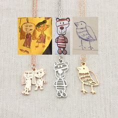 four different necklaces with pictures of animals and people on them, all in gold or silver