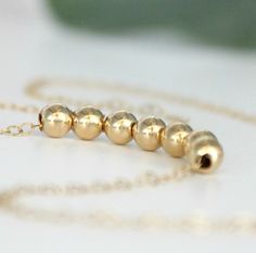 "14k Gold Filled Bead Necklace. A simple classic must-have for every woman, perfect for everyday wear. Choose from one to twenty beads or request a custom listing for more. Each dainty 6mm (1/4\") bead is strung onto a 14k gold filled cable chain that comes in several lengths... Choker style to layering... Simple elegance. If you have any questions please do not hesitate to contact me. Your order will arrive beautifully wrapped ready for gifting. Thanks so much for visiting my shop! Kay :)" Minimalist Gold Beads Necklace, Minimalist Gold Beaded Necklaces For Everyday, Minimalist Everyday Necklace With Gold Beads, Minimalist Gold Beads Necklace For Everyday, Minimalist Polished Beads Jewelry As A Gift, Minimalist Yellow Gold Necklace With Polished Beads, Classic Necklace With Spacer Beads For Gift, Rose Gold Necklace Simple, Chef Necklace