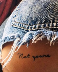 the back of a woman's stomach with words written on her left side and an inscription that says not yours