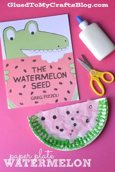 paper plate watermelon seed craft with scissors, glue and book on pink background