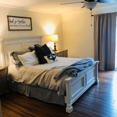 a white bed sitting on top of a wooden floor