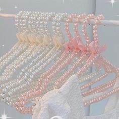 there are many different types of pearls on the clothes line, including pink and white