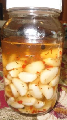 a jar filled with lots of food sitting on top of a table