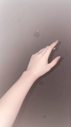 a person's hand reaching up into the air