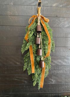 an evergreen wreath with bells hanging from it