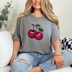 The cozy, oversized Comfort Colors t-shirt boasts a vibrant cluster of juicy red cherries, perfect for summer harvests and Cherry Festivals. If cherries are your fruit of choice, then this shirt is tailor-made for you. Available in t shirt colors, White, Crunchberry, Red and Grey.  .: The Comfort Colors 1717 tee is made with medium fabric (6.1 oz/yd² (206.8 g/m consisting of high quality, 100% ring-spun US cotton for long-lasting comfort. .: The relaxed fit keeps the wearer comfy in both casual and semi-formal settings while the crew neckline delivers that classic, neat style which makes it perfect for accessorizing.  .: The pre-shrunk fabric ensures a consistently great fit. Check all available sizes in our Comfort Colors 1717 size chart.  .: All Comfort Colors 1717 shirts feature pre-shr Trendy Red T-shirt For Summer, Cherry Short Sleeve Tops For Summer, Trendy Fruit Design Tops For Spring, Trendy Cherry Colored Tops For Summer, Casual Cotton Tops With Fruit Design, Red Fruit Print Top For Spring, Spring Fruit Design Short Sleeve Tops, Casual Cotton Top With Fruit Design, Casual Cherry Summer Tops