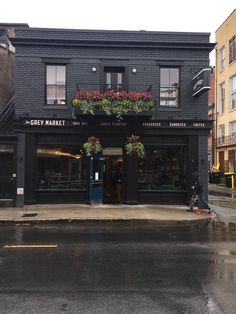 a black building with flower boxes on the front