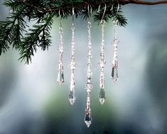 a group of crystal hanging from a tree branch