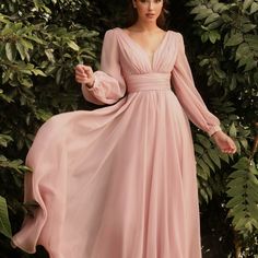 This Dreamy Chiffon Gown Features A Layered A-Line Skirt Gathered At The Waist. Sheer Long Sleeves Drape The Arms Up To The Gathered Deep V-Neckline Bodice And Ruched Waistband. The Back Has A Mid-Opening Allowing For Bra Strap Coverage. Color Blush Tags; Wedding Dress Mother Og Brdie Dress Party Dress Formal Long Sleeve Dress Formal Wear Evening Long Dress Black Formla Gown Ball Gown Bridal Collection Summer Wedding Dress Long Chiffon Dress With Sleeves, Formal Dresses Long Elegant Plus Size, Belle Sleeve Dress, Long Arm Dress, Tulle Dress With Sleeves, Pastel Dress Formal, Party Gowns Elegant, Chiffon Outfit, Elegant Evening Dresses Long