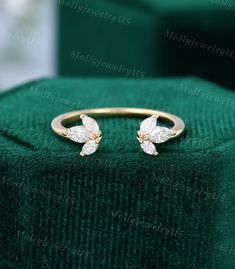 a gold ring with two diamonds on it