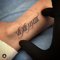 a person with a tattoo on their arm that reads, vexemumm