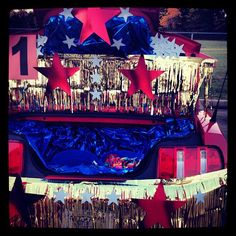 the back end of a car decorated with red, white and blue stars