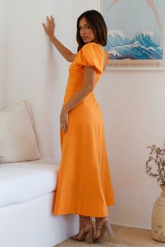 Get kissed by the sun on your next holiday in the Feeling Tanned Maxi Dress in Orange. This flowy dress is designed to follow you as you stroll around in the hot summer and clear skies kind of weather. Pair with loose waves and sandals. Maxi dress. true to size V neckline Knot bust design with keyhole Puff short-sleeves Invisible back zipper Soft pleats throughout dress Semi-lined 45% Cotton 55% Linen. Lining: Rayon Non-stretch Please refer to the care label on your garment for specific instructions on how to care for it Model wears XS Length from shoulder to hem: 130cm on an S Chest 34cm. Waist 30cm. size S Summer Orange V-neck Midi Dress, Spring Beachwear Maxi Dress With Short Sleeves, Spring Short Sleeve Maxi Beach Dress, Casual Ruched Sundress For Beach, Breezy Spring Vacation Maxi Dress, Breezy Maxi Dress For Spring Vacation, Orange Sundress For Summer Brunch, Flowy Sundress For Brunch And Vacation, Casual Ruched Maxi Dress For Beach Season