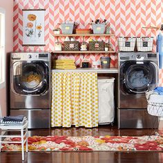 a washer and dryer sitting in a room next to a shelf with baskets on it