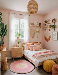 a bedroom with pink walls and white bedding, potted plants on the wall