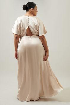 a woman in a white dress with her back to the camera