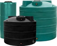 three large green and black tanks sitting next to each other