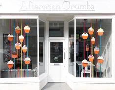 the front entrance to afternoon crumbs is decorated with cupcakes and icing