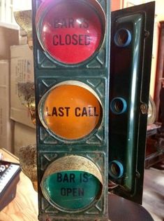 a traffic light that has the words last call and bar is open written on it