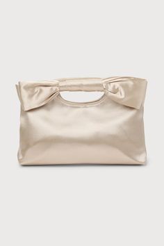 Complete your big day look with the Lulus Total Romantic Champagne Satin Bow Clutch! Sleek woven satin shapes darling clutch that has a cutout handle at the top and a decorative bow at the front. Magnetic closure opens to a lined interior with a single sidewall pocket. Detachable silver chain strap. Fully lined. Bag measures 10. 5" wide, 7. 5" tall, and 1. 75" deep (relaxed). Detachable 47. 50" strap. Strap has a drop of 22â€. Shell: 100% Polyester. Lining: 100% Polyester. Do Not Wash. Do Not Bleach. Do Not Dry Clean. Wipe With Damp Cloth. Imported. Lulus | Total Romantic Champagne Satin Bow Clutch | 100% Polyester. Clutch Bag Pattern, Prom Clutch, Satin Purses, Bow Clutch, Bridesmaid Clutches, Bridal Bag, Bridesmaid Bags, Over The Shoulder Bags, Spring Bags