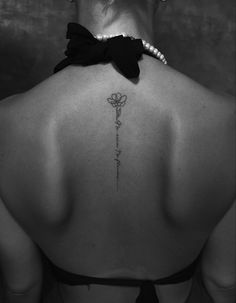 a woman with a flower tattoo on her back