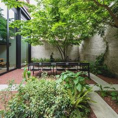 an outdoor dining area with benches and trees