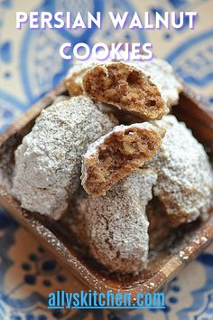 some type of dessert in a blue and white bowl with the words persian walnut cookies above it