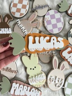 someone is holding up some stickers with the word lucas on them and an image of rabbits